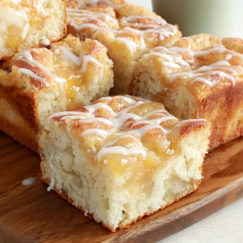 A slice of peaches and cream focaccia with jelly drizzled on top.