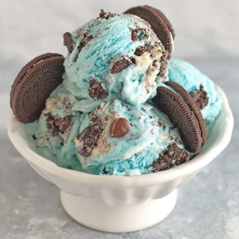 A bowl of ice cream with cookies on top.