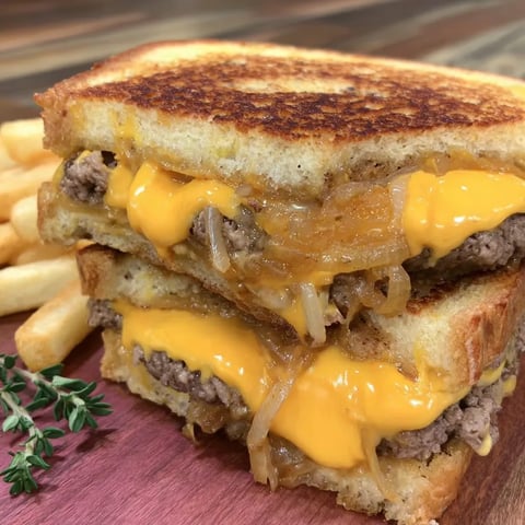 A stack of sandwiches with cheese and onions.