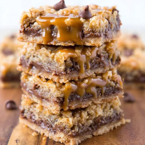 A stack of carmelitas with chocolate drizzled on top.