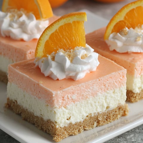 Two slices of orange creamsicle dream bars.