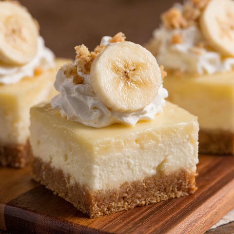 Two slices of banana pudding cheesecake bars.
