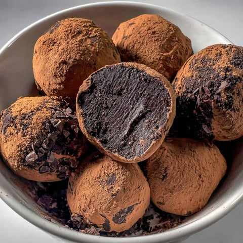 A bowl of dark chocolate truffles.