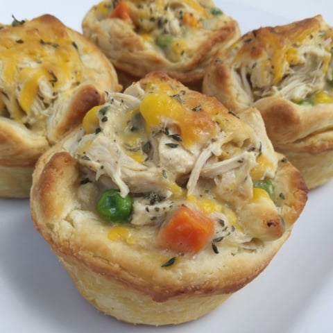 A muffin tin filled with chicken pot pie.