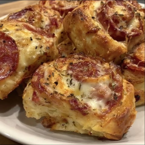 Pepperoni pizza rolls on a plate.