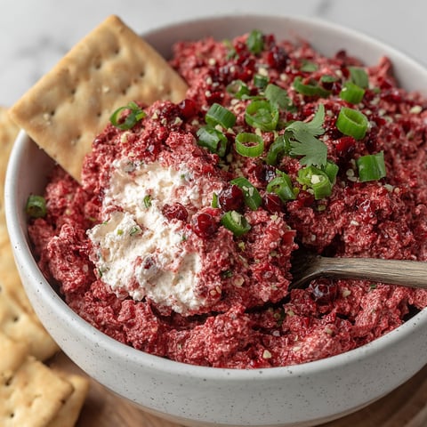 A bowl of Cranberry Jalapeño Cream Cheese Dip.