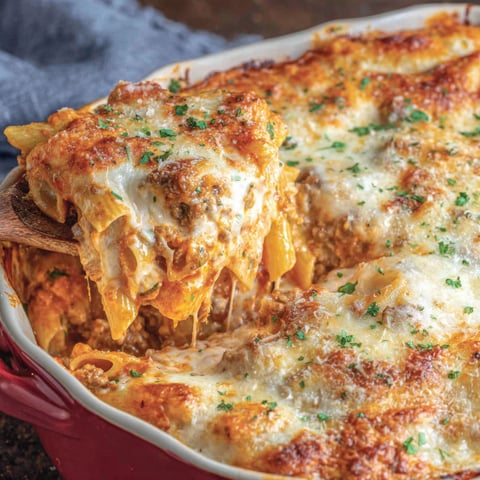 A red bowl filled with mostaccioli.