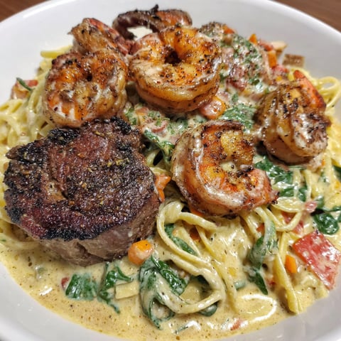 A plate of food with shrimp and meat.