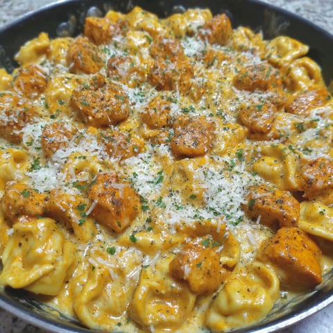 A plate of buffalo chicken tortellini alfredo.