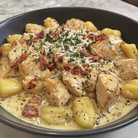 A bowl of creamy chicken and gnocchi.