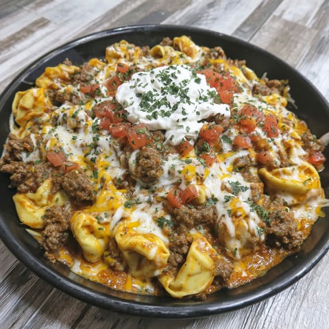 A bowl of cheesy beef enchilada tortellini.